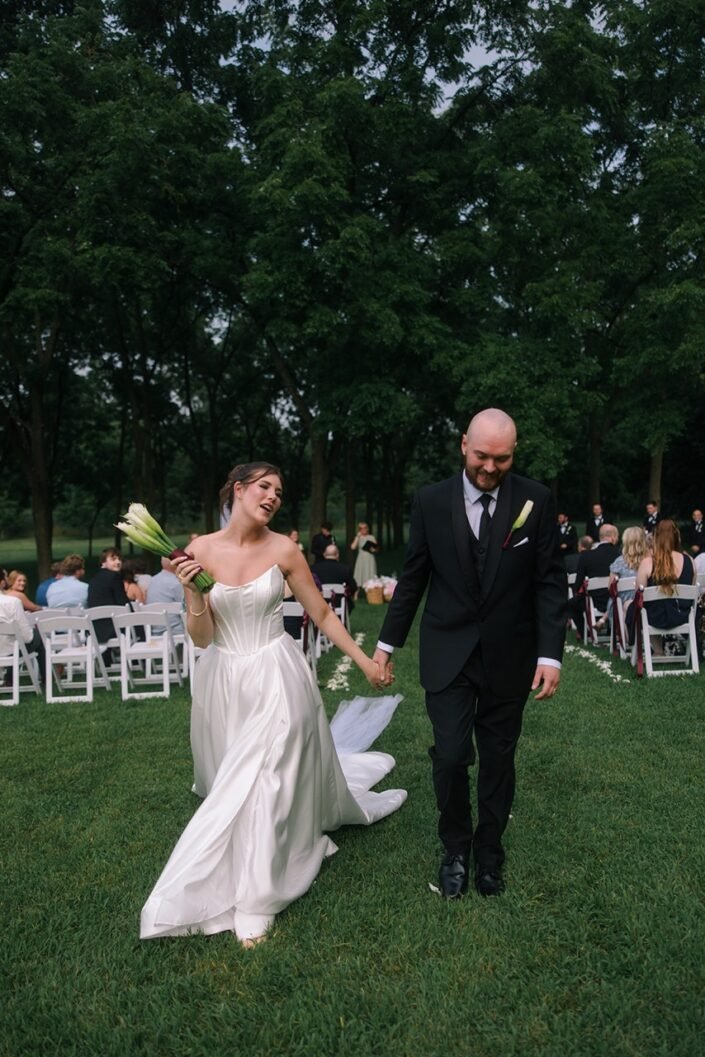 Bride and groom laughing together during their outdoor wedding reception in Wisconsin