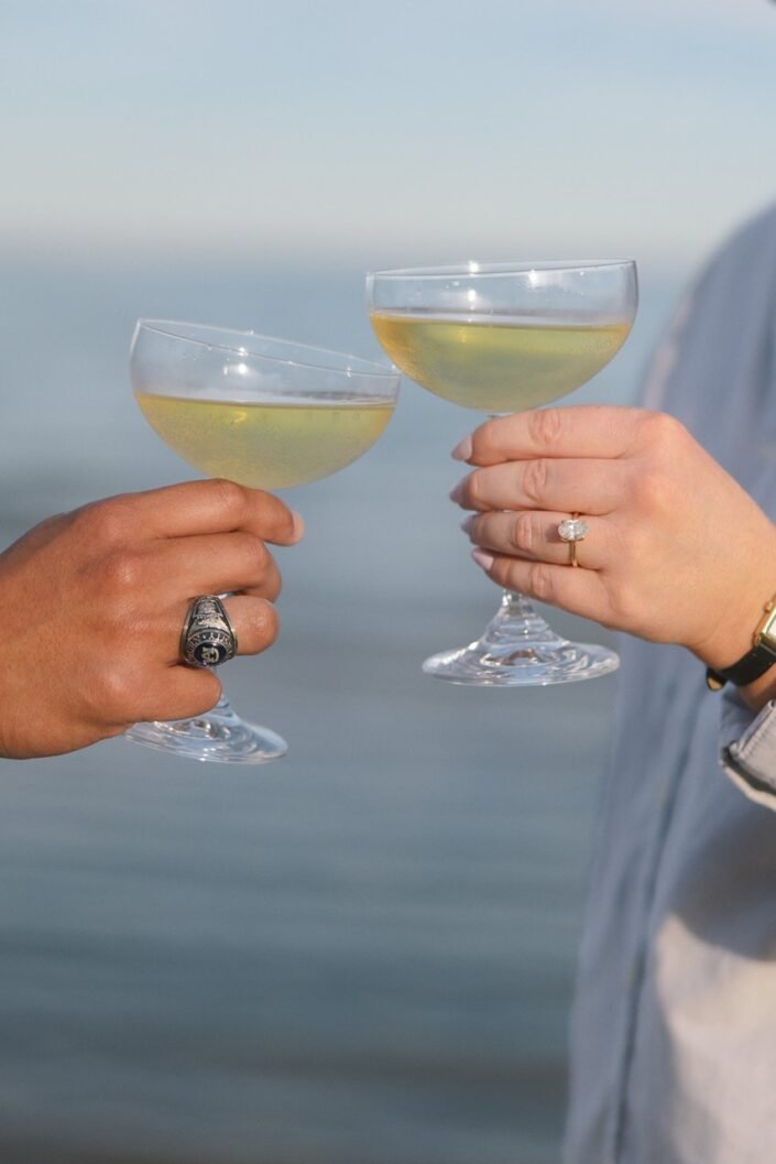 Nick and Katharine sipping champagne together during their engagement photos.